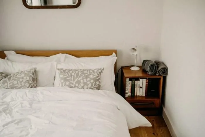 A neatly made bed under a quilted comforter