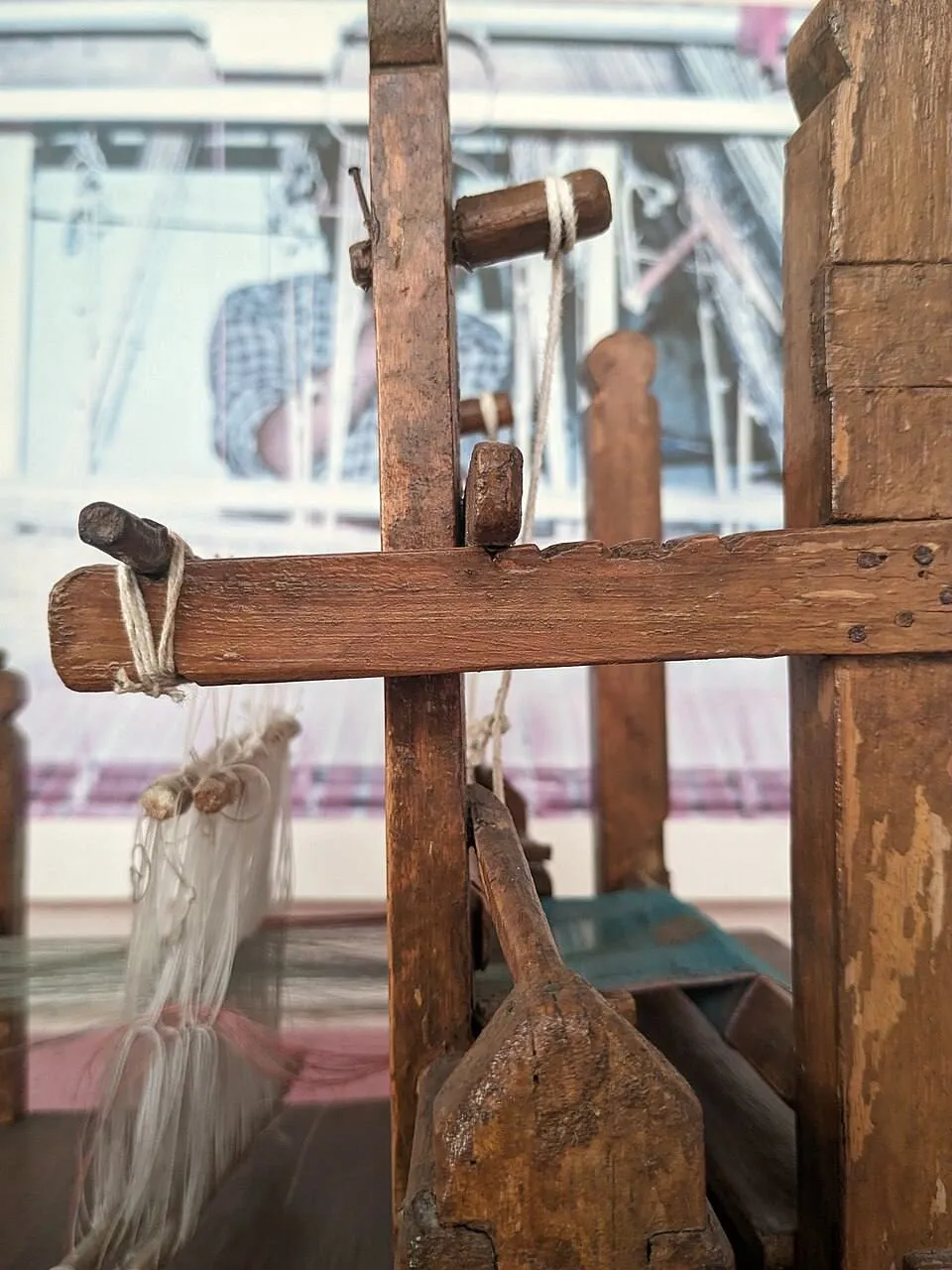 A wooden handloom with warp threads under tension
