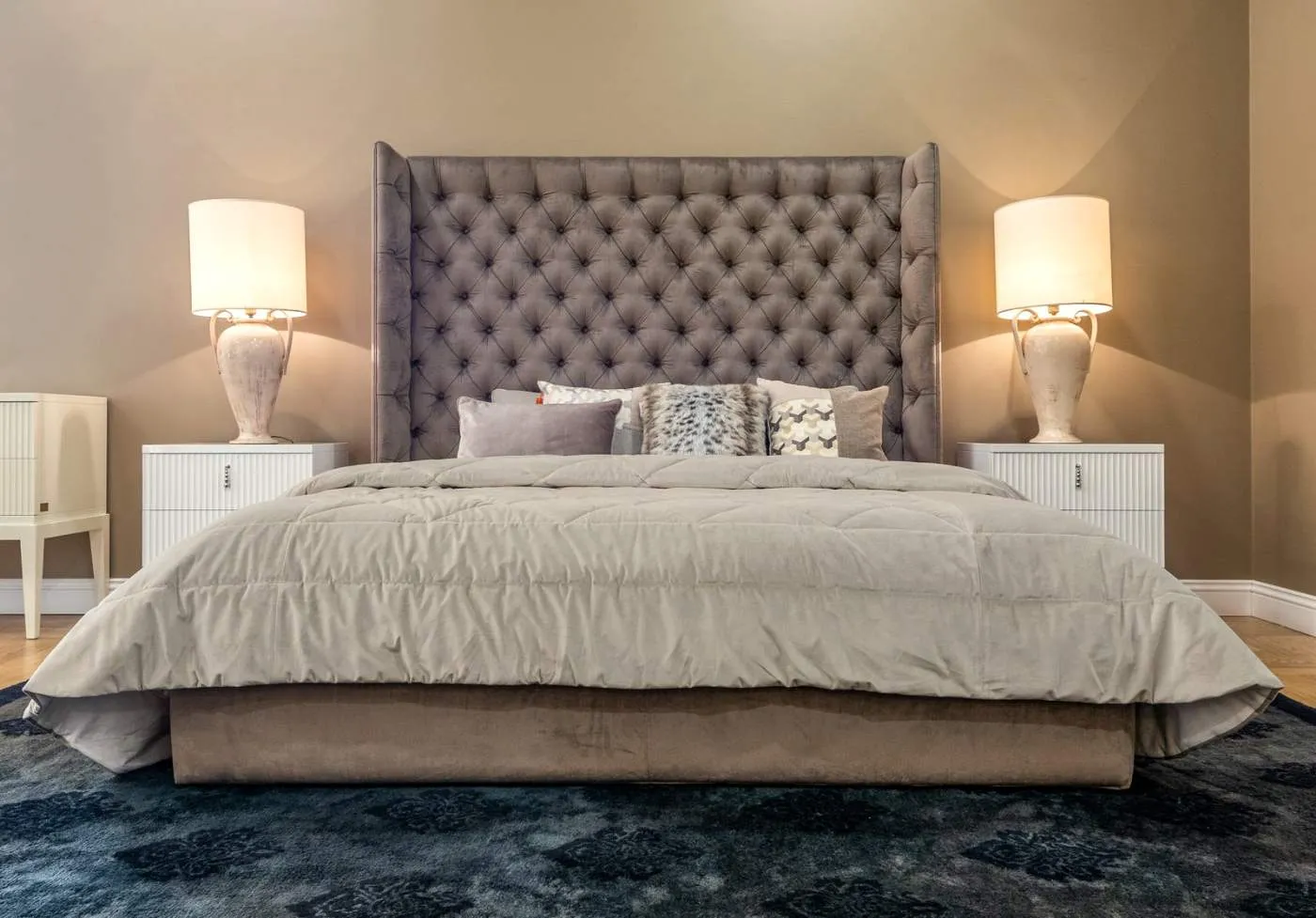A bed made up with a quilted comforter and layered pillows