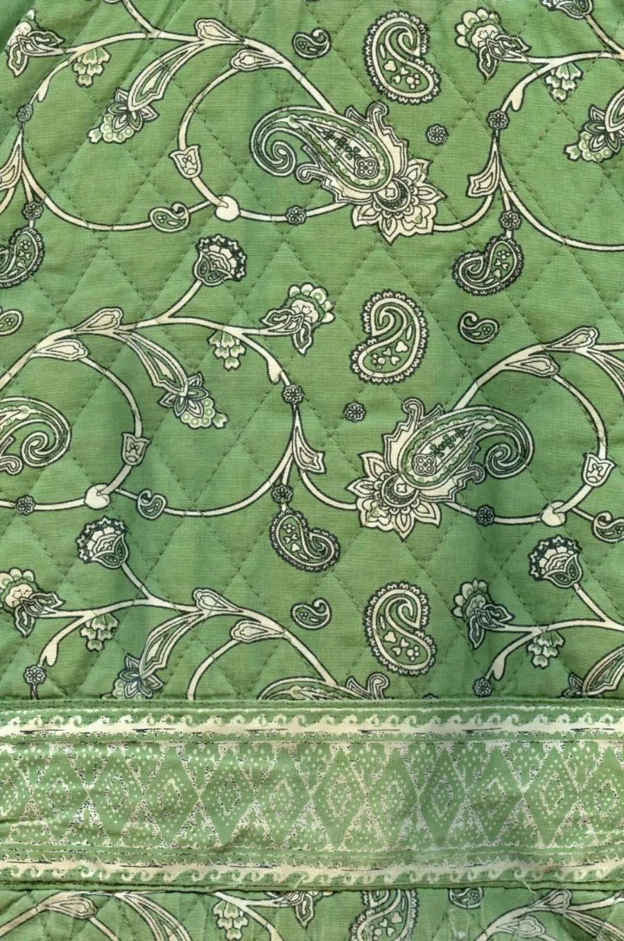 A printed paisley quilt, stitched flat