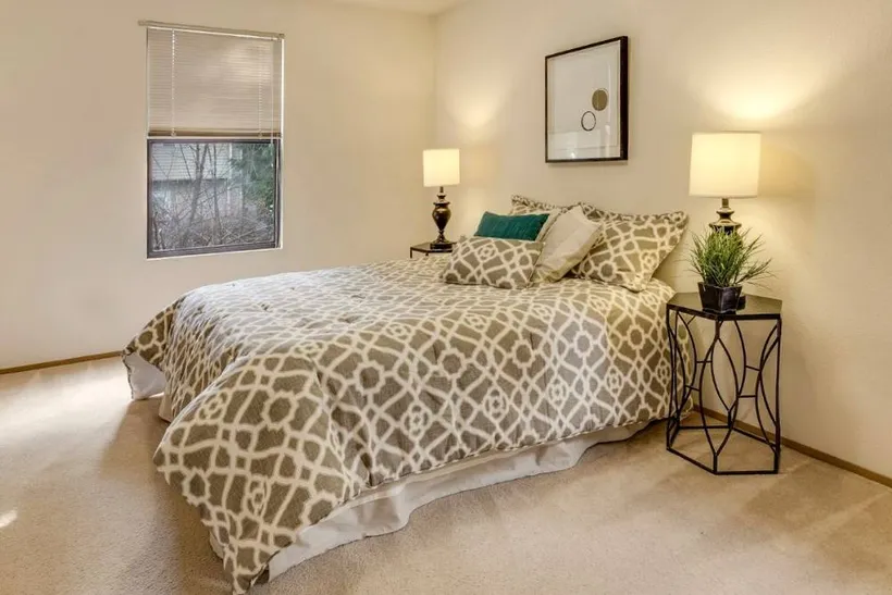 A bed made up with a patterned cotton bedspread